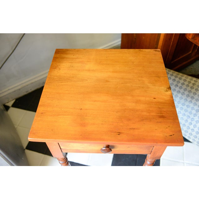 This antique American Sheraton one drawer stand, dating to the mid-19th century, is features signature turned legs,...