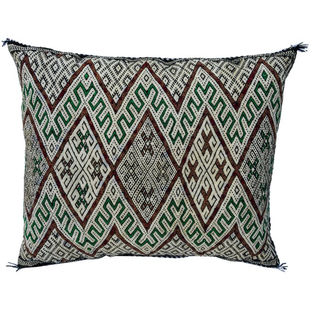 Vintage handwoven pillow by the Berbers of the High Atlas Mountains of Moroccan. Features a finely-woven design consisting...