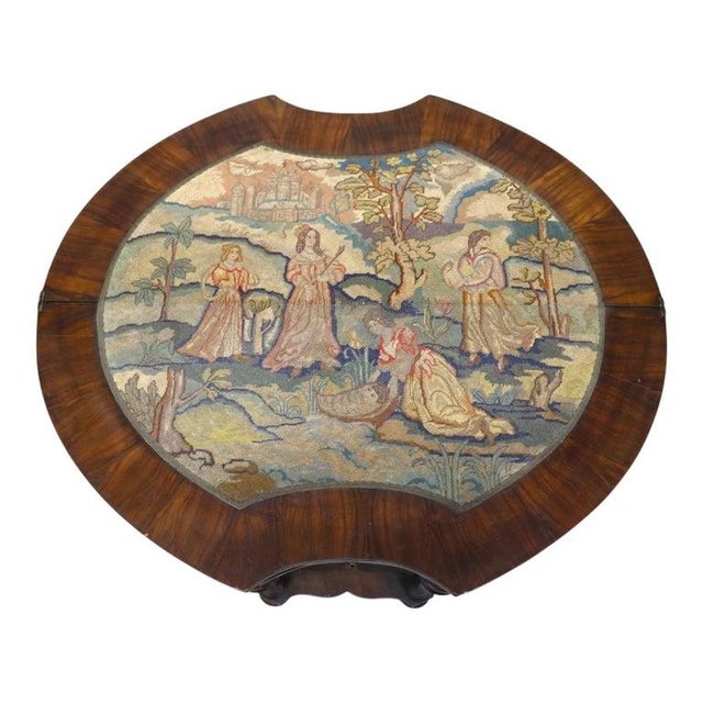 An English early 19th-century walnut game table, described as circa 1810, with burl-veneered surfaces and a central petit...