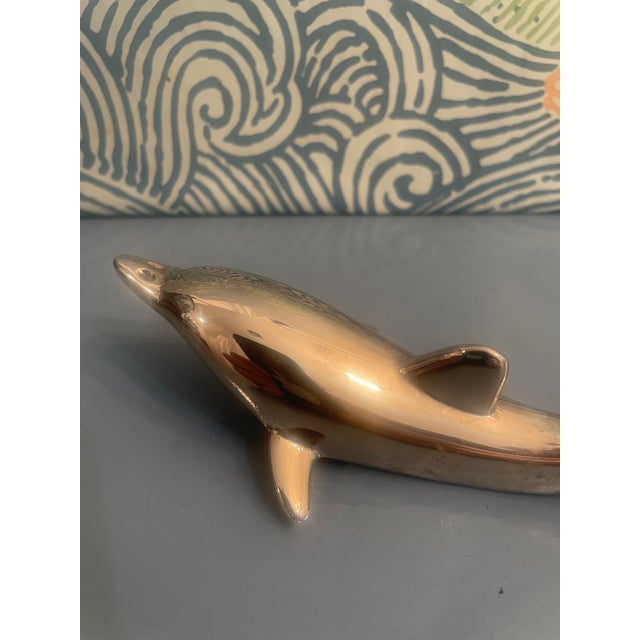 Straight out of the Mid Century, this playful silver plate dolphin is the perfect accessory for your bar cart or cabinet....