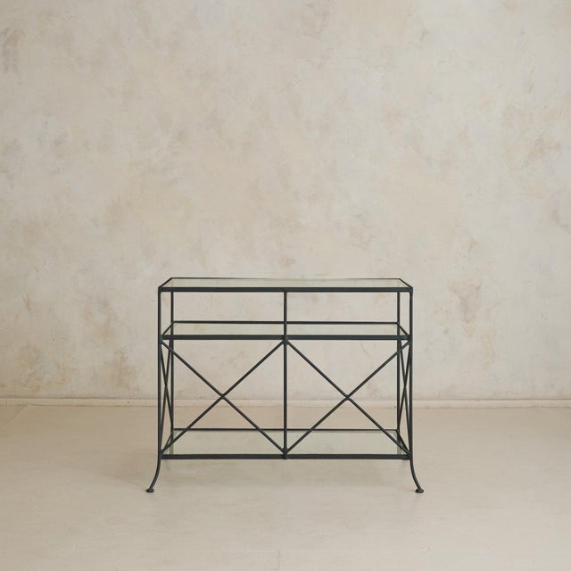 Line and structure define this vintage French iron and glass console from La Roque, France dating to the 1980s, where...
