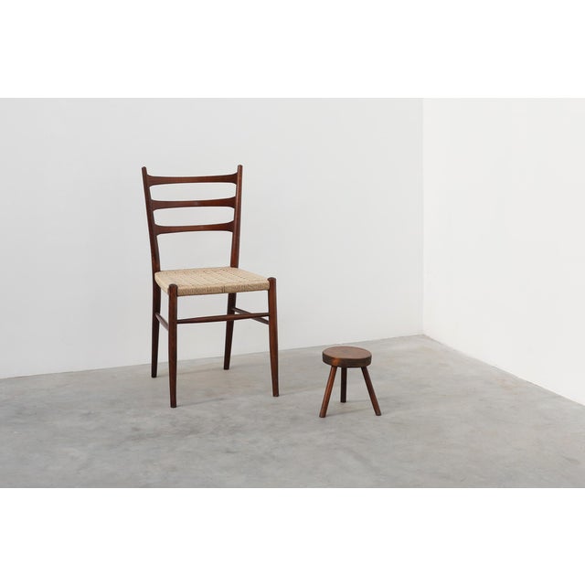A charming rustic oak tripod stool from France, dating to around 1900. This small, sculptural piece embodies the honesty...