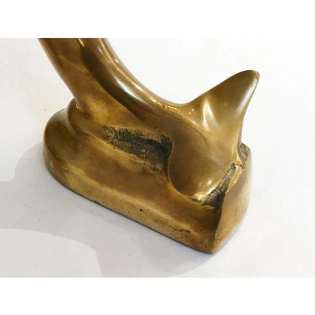 Pair of Dolphin Zoomorphic Serres-Books, represented on their tail; in golden brass.