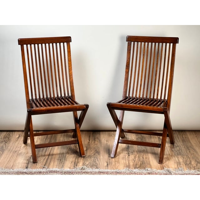 This handsome pair of vintage folding chairs embodies the clean architectural lines and understated elegance associated...