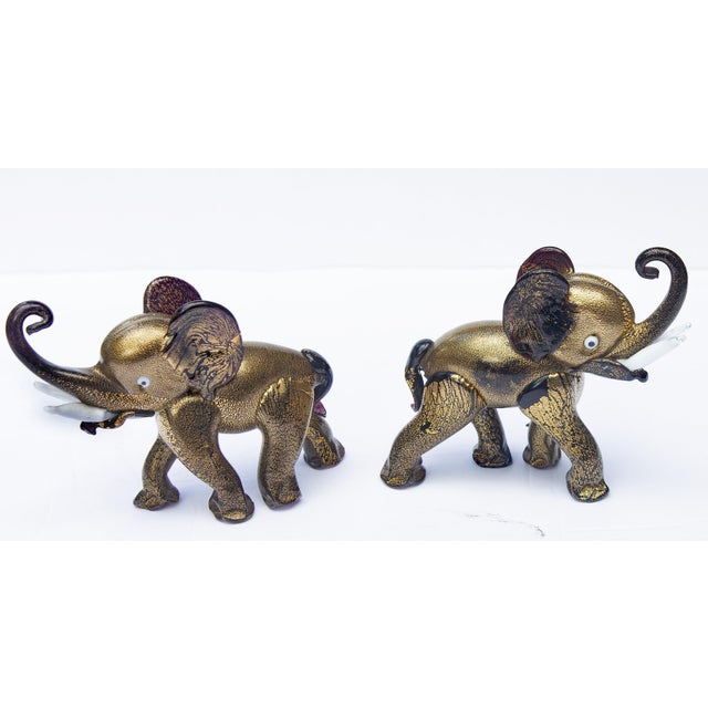 Pair of playful Murano glass elephants. Dark nearly black amethyst glass with lots of gold. Circa 1950's. Possibly by...