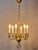An antique six-arm bronze chandelier from the 19th century is an elegant example of historical interior lighting,...