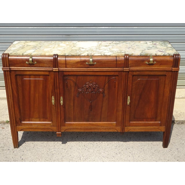 Art Deco style sideboard with three doors and three drawers. The top is made of light marble, Aleppo breccia, with a light...