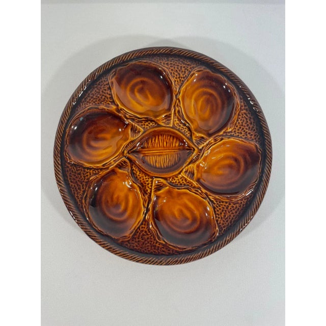 A handsome vintage French Majolica Ceramic Oyster Plate made by St. Clement in France. Circa 1960s. Maker's mark imprinted...