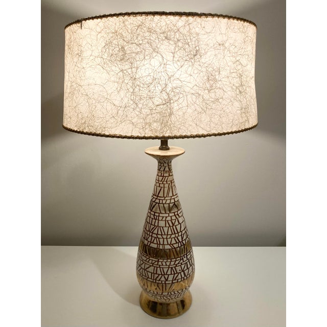 Break out the vinyl records! This vintage ceramic lamp is the perfect hit of "retro" for your space. While there is some...