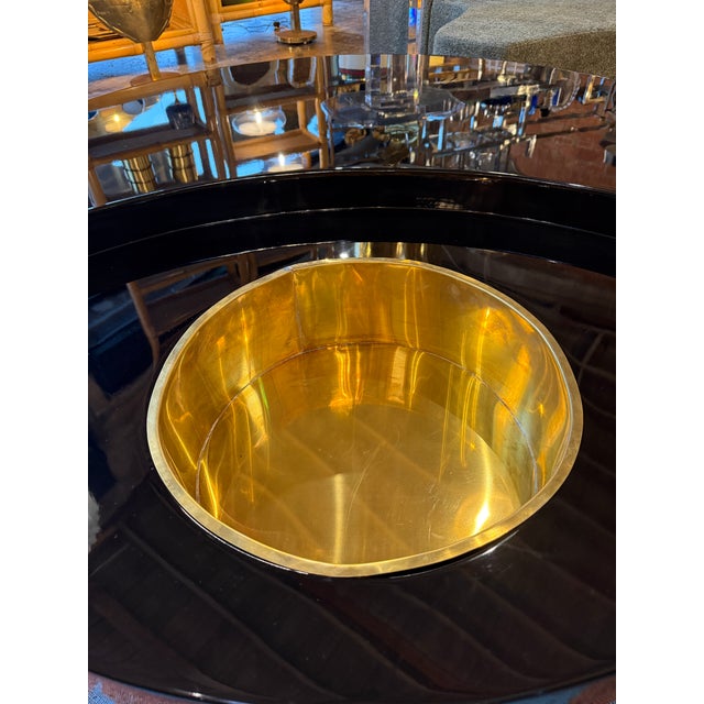 The TRG coffee table by Willy Rizzo, presented in its lacquered black finish, stands among the most emblematic creations...