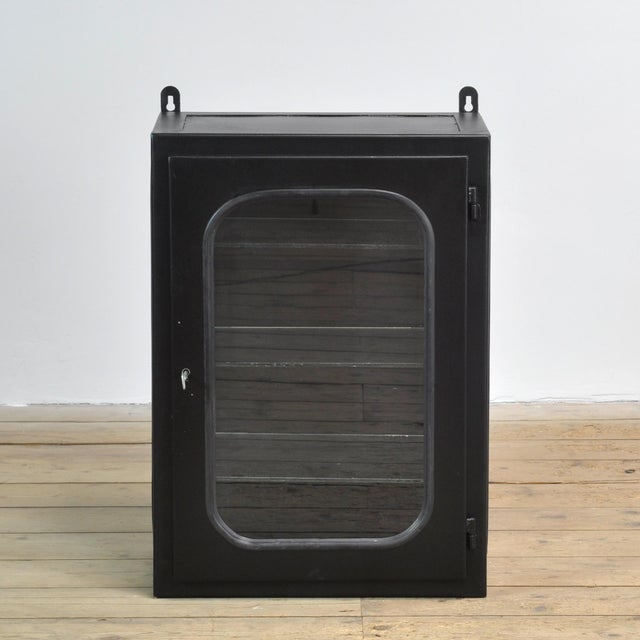Hospital medicine cabinet (wall unit). Made of iron and glass held in place by a rubber strip in the steel. This cabinet...