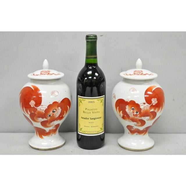 Vintage Chinese Hand Painted Foo Dog Porcelain Covered Ginger Jars - a Pair. Circa Early 20th Century. Measurements: 9" H...