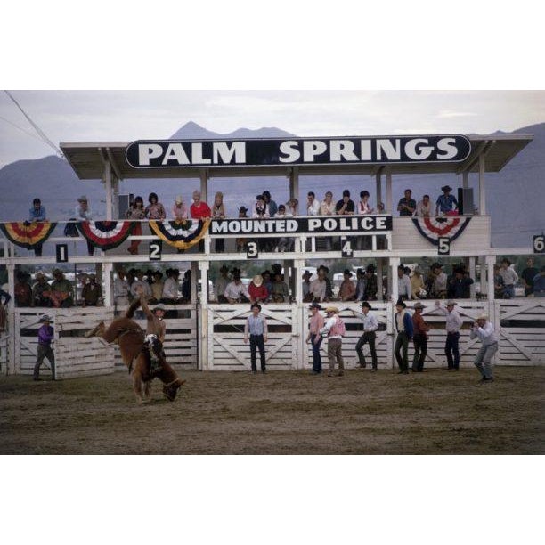Palm Springs Rodeo 1970 Spectators watch from the stand as a contestant rides a bucking horse at the Palm Springs Mounted...