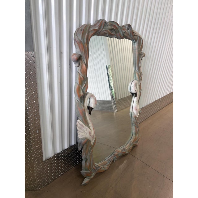 This is a jaw dropping vertical wall mirror. It is 59 inches tall. It features swans and palm leaves. It is solid wood...