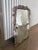 This is a jaw dropping vertical wall mirror. It is 59 inches tall. It features swans and palm leaves. It is solid wood...