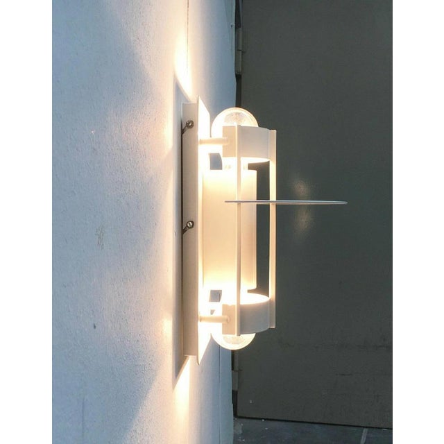 Saturn wall lamp from the Danish lighting manufacturer Louis Poulsen based on a design by Joachim Lepper. Saturn has a...