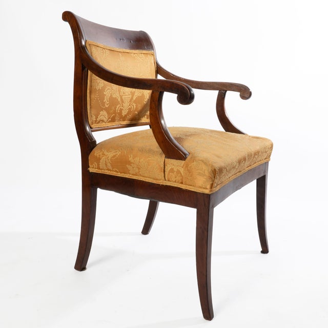 A gorgeous 19th century English regency inlaid mahogany elbow chair that will make a statement an any room in your home.