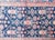 A finely woven Persian Malayer rug from the early 20th century, featuring a rich navy field filled with floral sprays and...