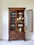 Crafted in the early 20th century from English oak, this handsome leaded glass bookcase features a rich, time-worn patina...