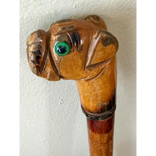 Quintessential folk art American cane with a well modeled head of a bulldog as the crook with green glass eyes and...
