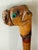 Quintessential folk art American cane with a well modeled head of a bulldog as the crook with green glass eyes and...