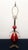 Elevate your space with this striking mid-century modern table lamp, featuring a luminous, teardrop-shaped ruby red cased...