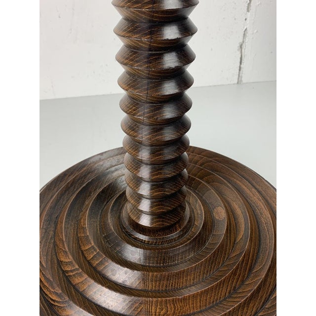 Stunning French side table of pedestal from the 1940s- 1950s constructed in brown oak. The bases are generally made of...