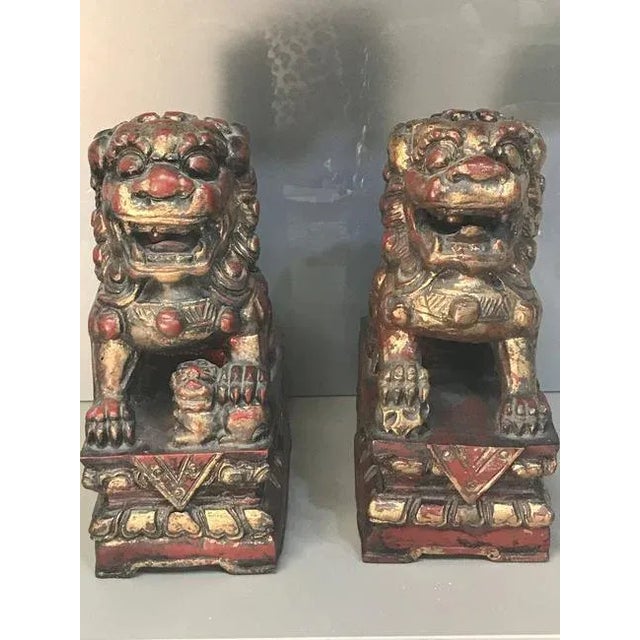 A pair of Antique 19th Century Gilt and Red Painted Foo Lion sculpture