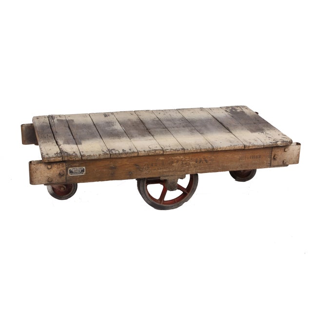 A vintage factory cart that would make a perfect coffee table. Oak planks and framing, iron hardware, and rubber wheels. A...