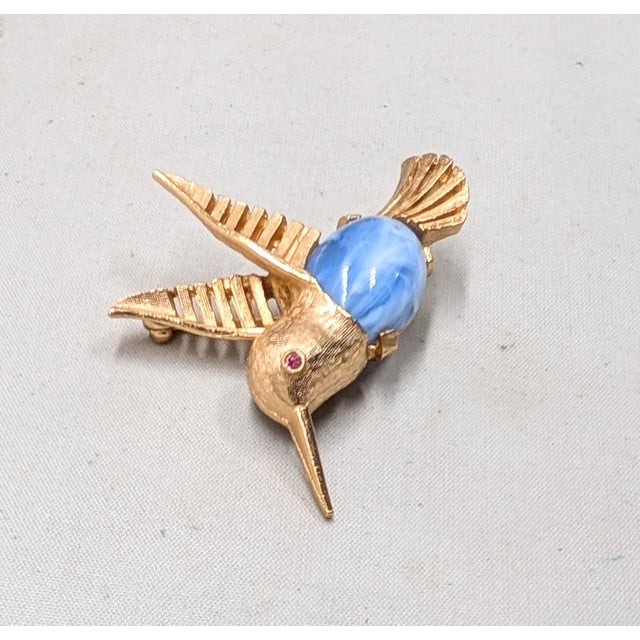 1960s textured goldtone baby blue with white swirl resin cabochon belly with small round faux-ruby eye hummingbird brooch...