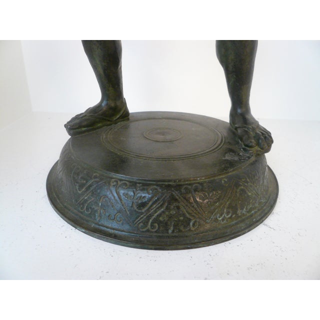 This 19th Century bronze figure of Silenus, God of wine, and tutor of Dionysus, is depicted wrestling a serpent. The...