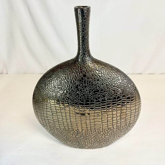 Vintage Home is pleased to offer this Faux Reptile Skin Ceramic Vase. The Post-Modern vase is a metallic brown with a...