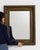 A 19th century French wall mirror designed in the Empire style, characterized by a structured and symmetrical frame. The...