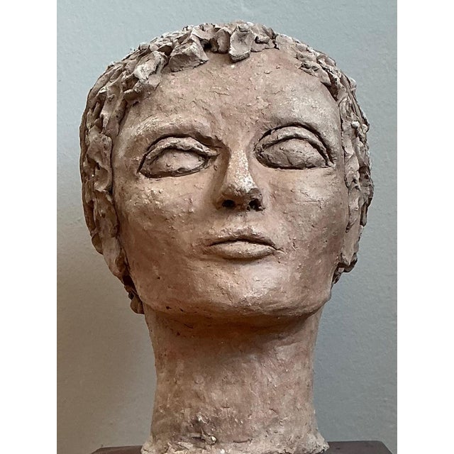 Exuding an air of quiet contemplation, this vintage plaster head sculpture is a striking example of Mid-Century artistic...
