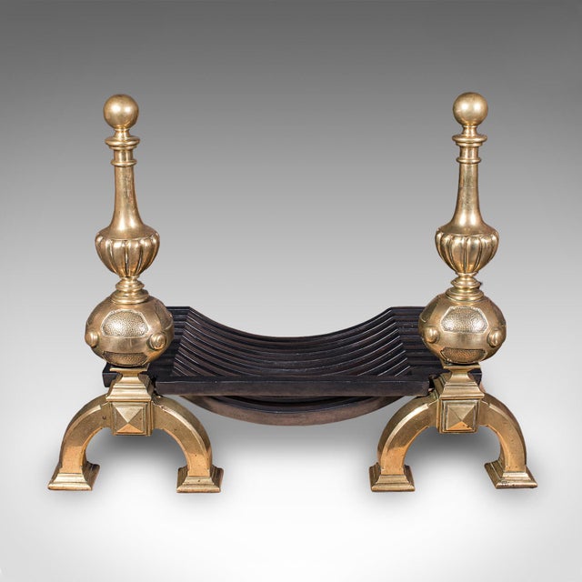 This is a grand antique fireplace set. An English, cast iron fire basket and polished brass andirons ensemble, dating to...