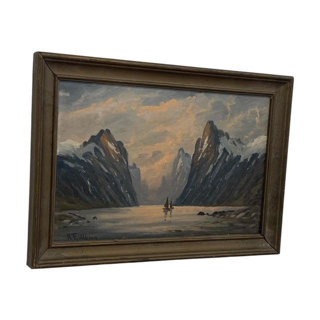 Vintage landscape painting depicting a dramatic fjord flanked by steep, snow-capped mountain peaks with two sailboats on...