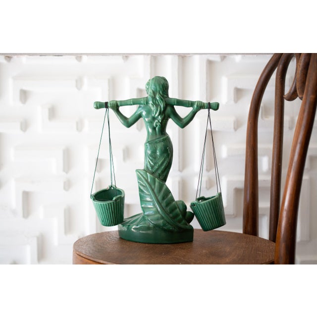 Very rare Gonder pottery from the Ceramic Arts line. This piece depicts a woman carrying four bamboo buckets on her...