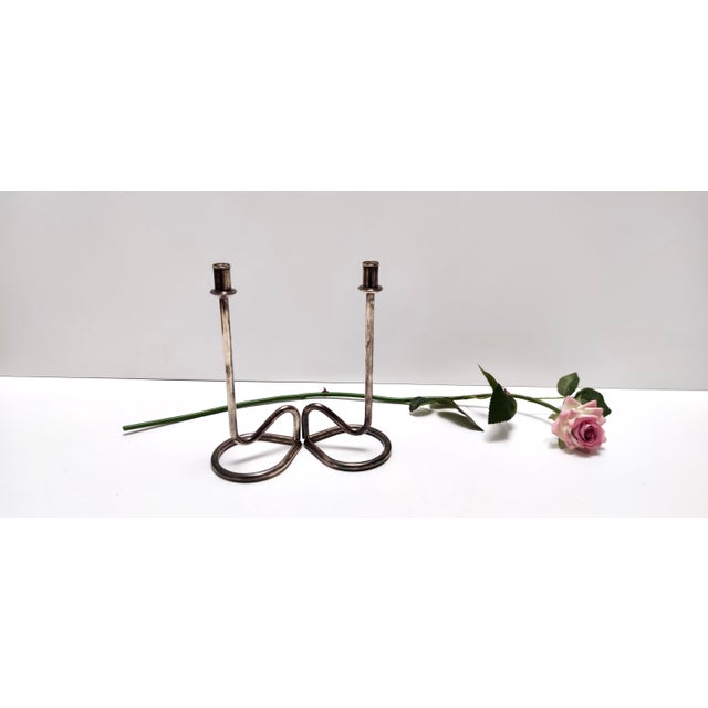 Made in Italy, 1990s. They are made in silver plated metal. These candleholder are vintage, therefore they might show...