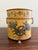 A gorgeous neoclassical yellow tole cachepot, planter, or vase with hand-painted details and brass lion paw feet Italy,...