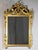 Rectangular mirror, with golden wood frame, of Louis XVI style. It is embellished with falling foliage on each side and...
