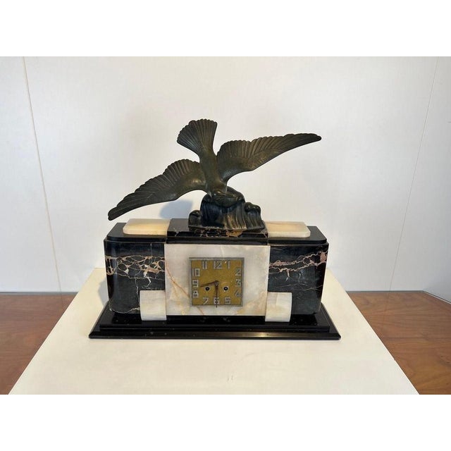 Original, well-preserved Art Deco mantel or table clock from France around 1930. Marble base in dark (Porto) and light...