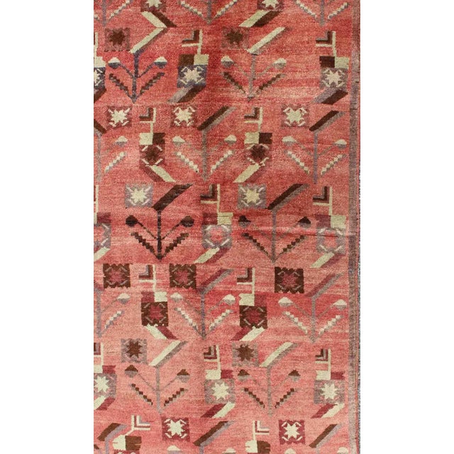 Turkish Oushak Vintage Carpet with Tribal Figures Set soft Red Pink Background Oushak Vintage Carpet with Tribal Figures...
