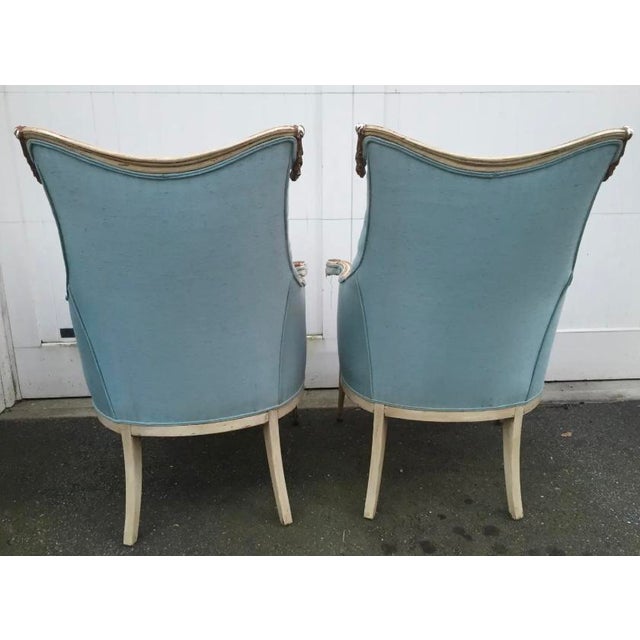 Carved wood decorative swags and fluted legs accent this stylish pair of armchairs, which are most likely from the 1940's....