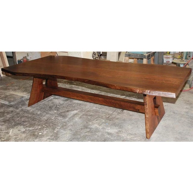 This live edge table is made from two 'sister-slabs' of book-matched black walnut. The top is made from the two center...