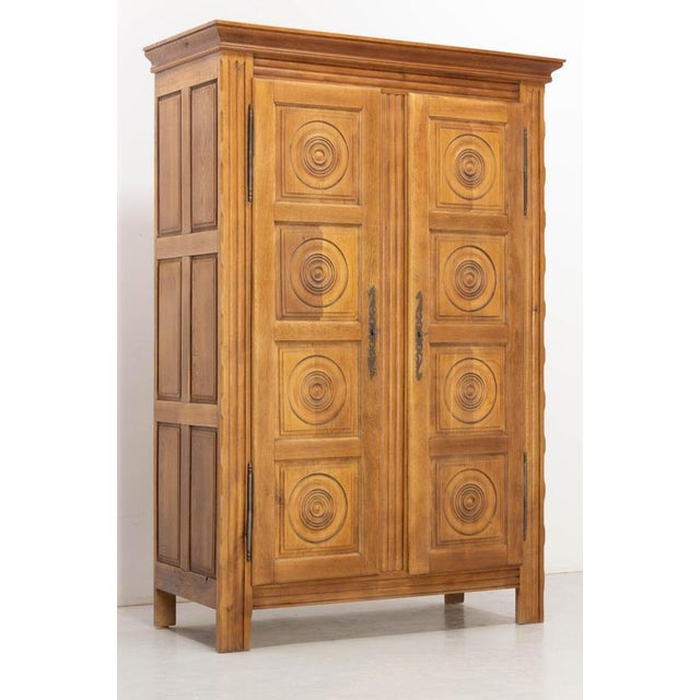 A beautiful French oak cabinet dating from the 1960s, in the style of Charles Dudouyt. It opens with two doors adorned...