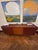 Classic Scandinavian credenza in teak, roughly 6 feet long. Two sliding doors with hand-carved oval finger pulls open to...