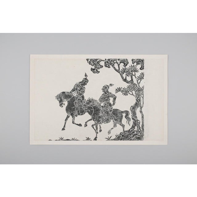 Framed Chinese rubbing on paper depicting 2 warriors on horseback. Frame measures 29" x 21 1/2" Rubbing set in matte,...