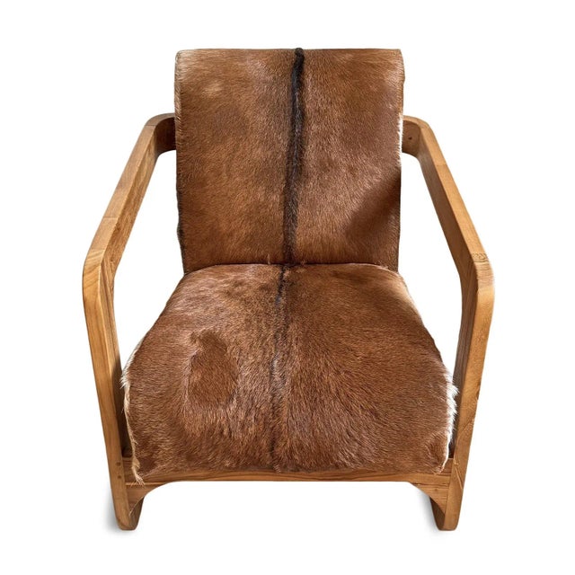 Beautiful natural goat hide upholstered arm chair with solid smooth teak wood frame. Each will have variations in hide...