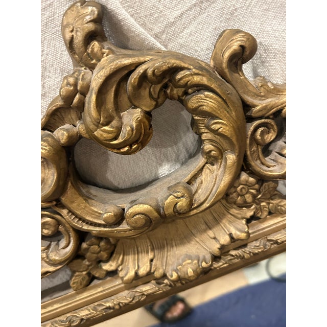 Vintage ornate wood mirror in gold. This is very heavy and has hanging material installed. It is from an estate and in...