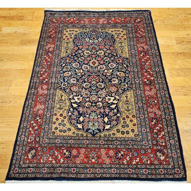 "This vintage Persian Tabriz rug from the early 20th century showcases an exquisite allover floral pattern on a deep navy...